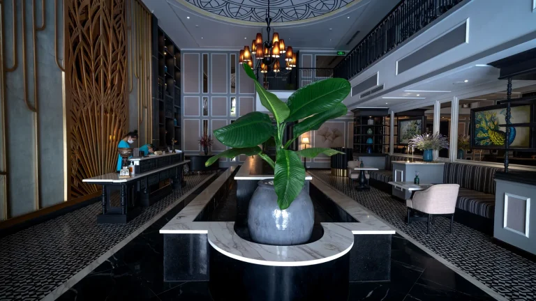 Hall d'hôtel moderne avec grande plante et comptoir d'accueil
